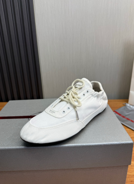 Prada white lace-up sneakers with gold eyelets