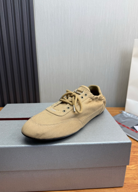 Prada tan lace-up sneakers with gold eyelets